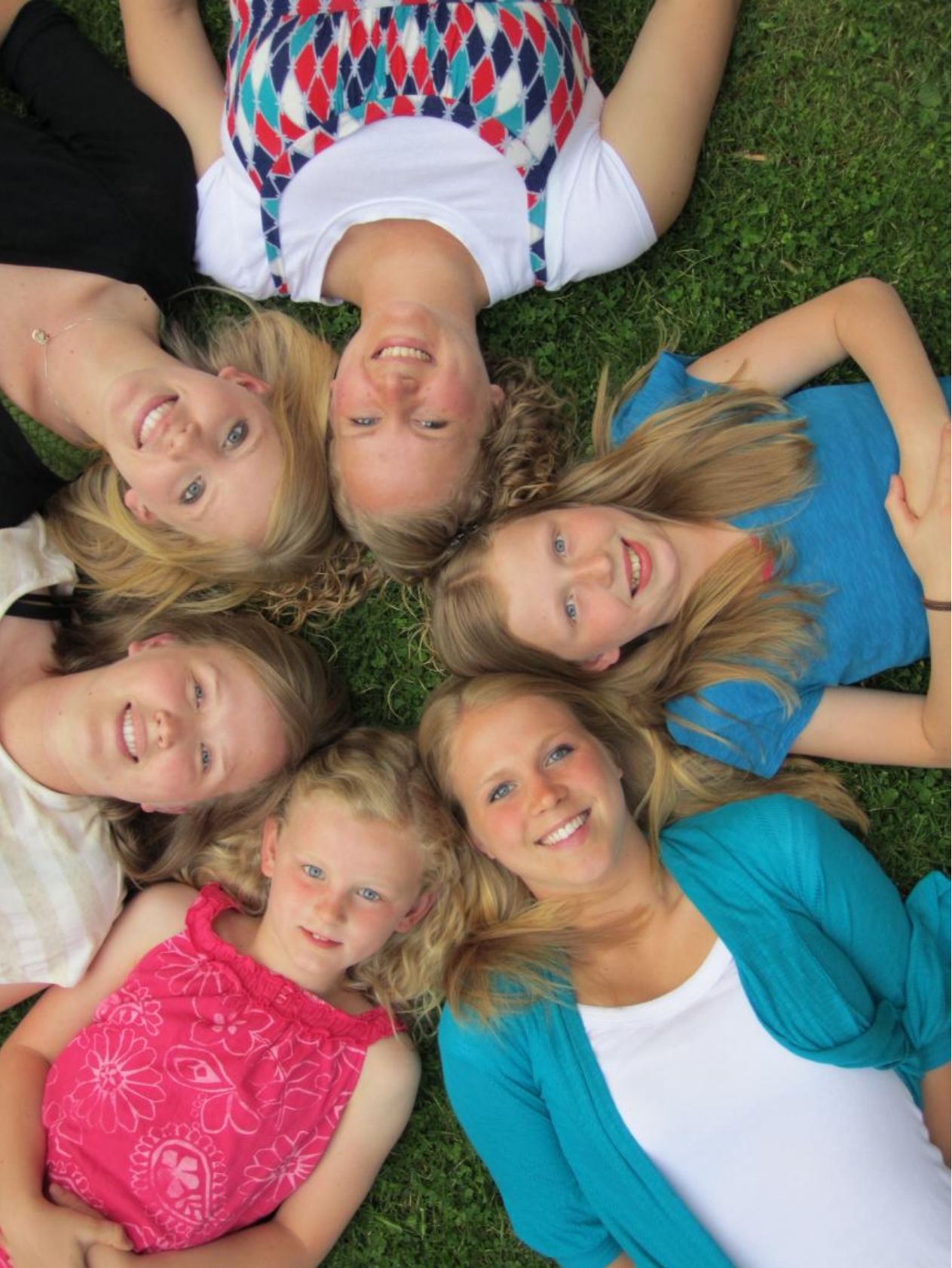 Photo from the 2011 Christmas letter: the King girls lying in a circle on the grass