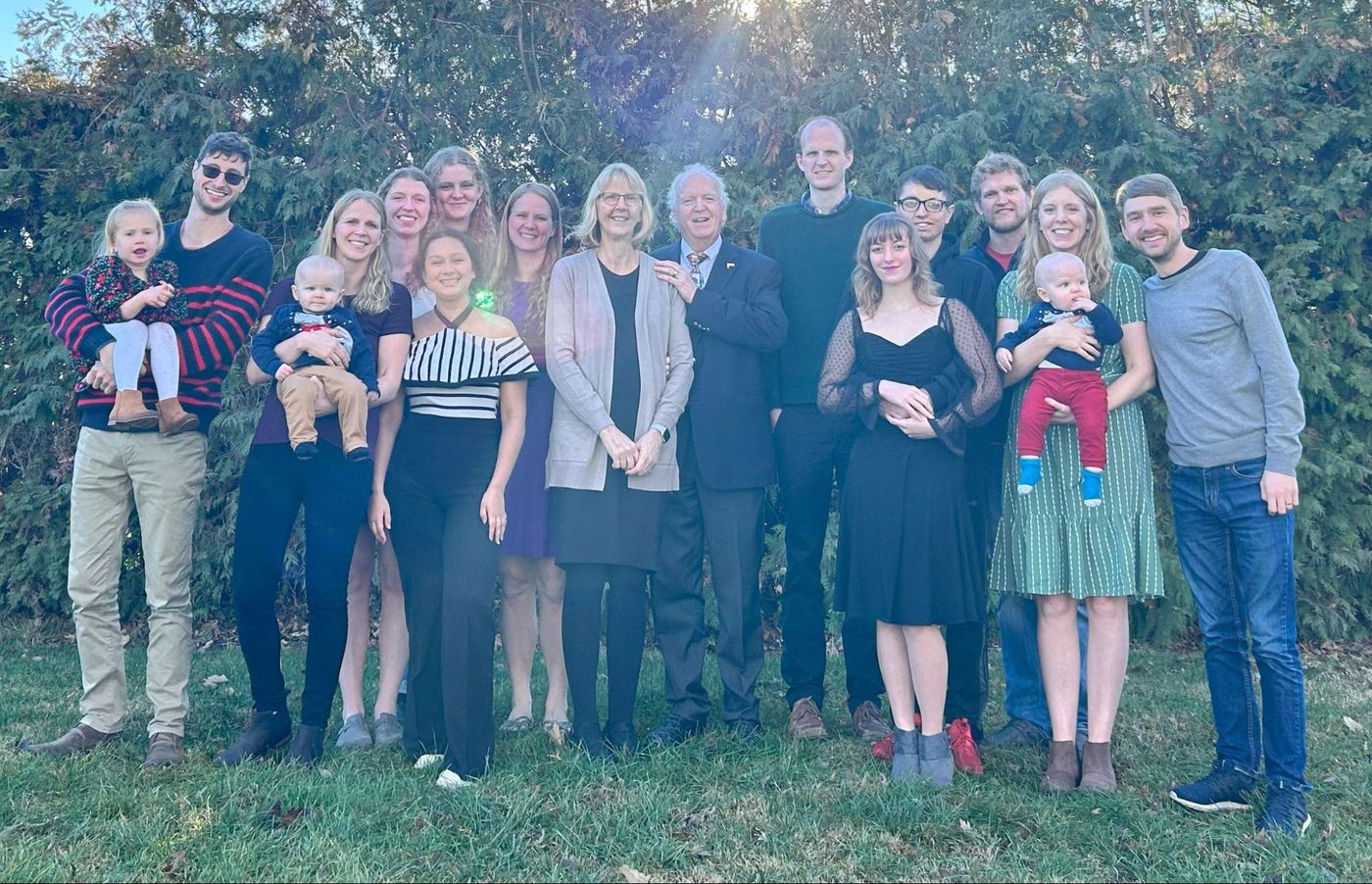 Photo from the 2023 Christmas letter: the extended King family standing together outdoors in front of trees